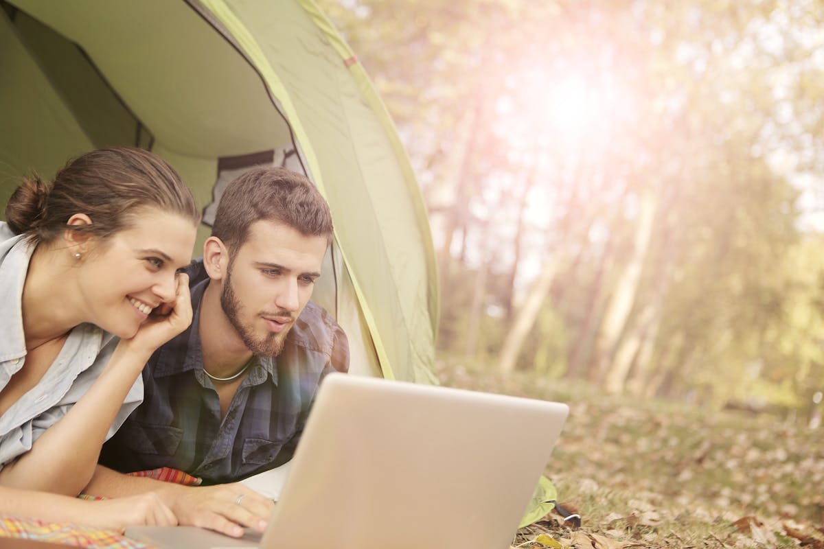 RV park manager reviewing reservation dashboard on laptop